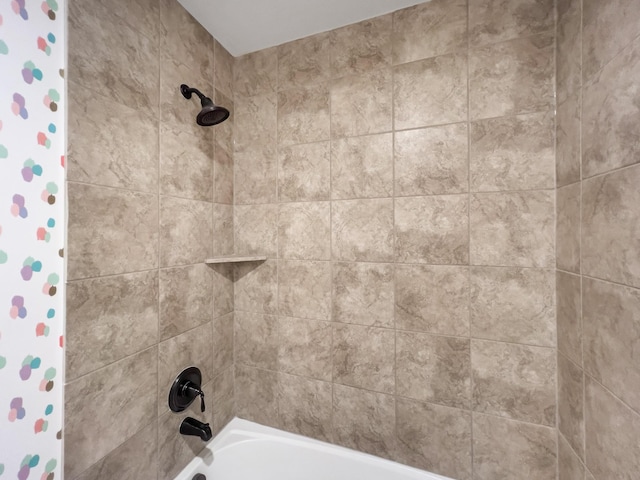 interior details featuring shower / bath combo