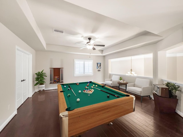 rec room with ceiling fan with notable chandelier, a tray ceiling, hardwood / wood-style flooring, and pool table