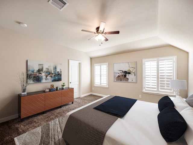 carpeted bedroom with ceiling fan and vaulted ceiling