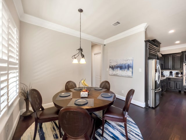 dining space featuring dark hardwood / wood-style floors, ornamental molding, and a notable chandelier