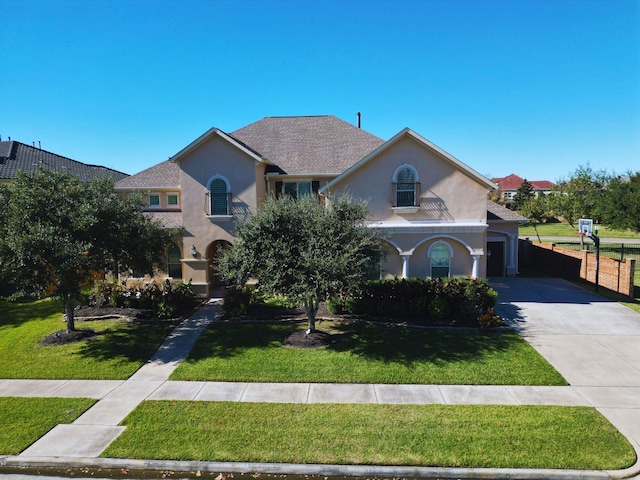 view of front facade featuring a garage and a front lawn