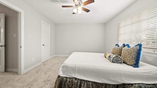 bedroom with ceiling fan and light colored carpet