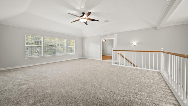 spare room with light carpet, a tray ceiling, and crown molding