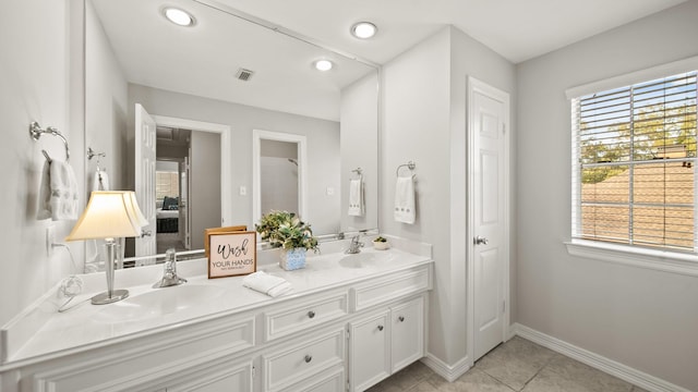 bathroom with tile patterned floors and vanity