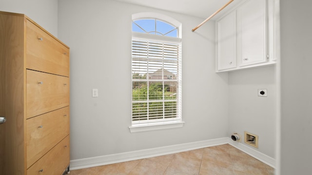 laundry room with cabinets, electric dryer hookup, and light tile patterned flooring