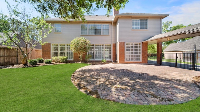 back of property with a patio area and a yard