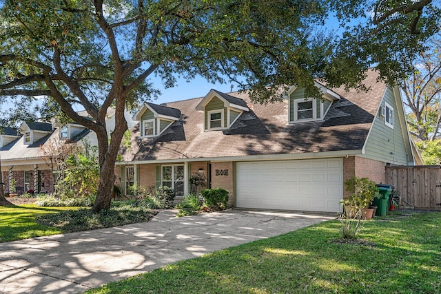 cape cod house featuring a garage and a front lawn