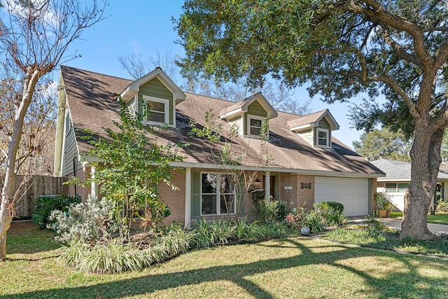 cape cod-style house featuring a garage and a front yard