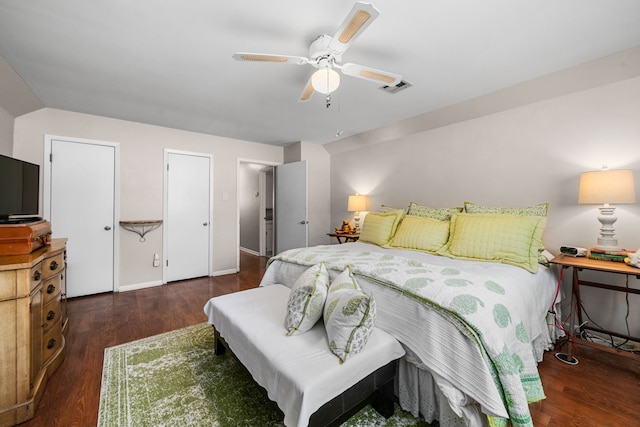 bedroom with dark hardwood / wood-style flooring and ceiling fan