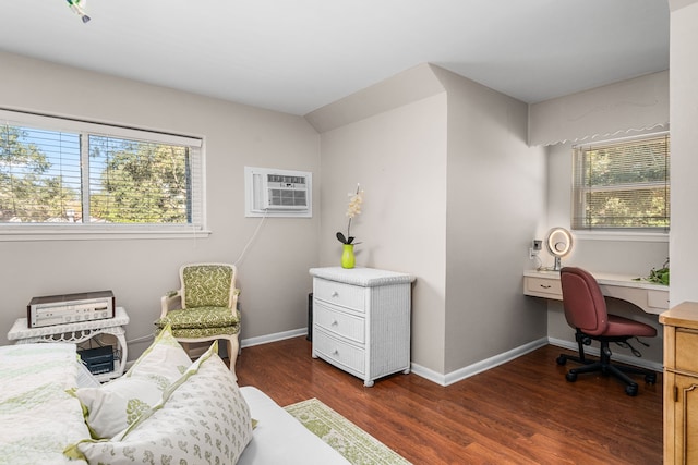 interior space with dark wood-type flooring, a wealth of natural light, and an AC wall unit