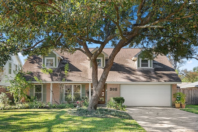 cape cod home with a garage and a front lawn