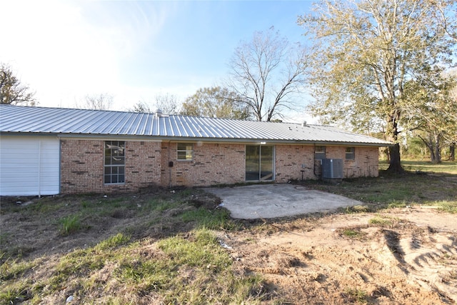 rear view of property featuring central air condition unit and a patio area