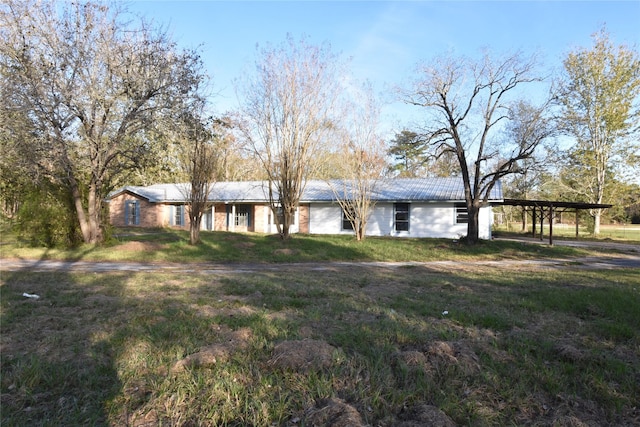 ranch-style home with a carport and a front yard