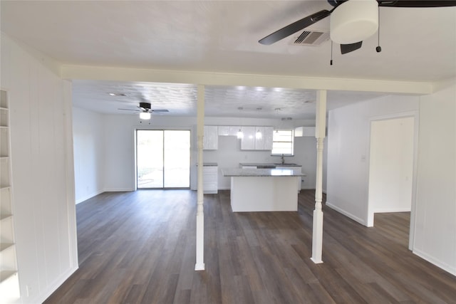 kitchen with ceiling fan, sink, white cabinetry, and dark wood-type flooring