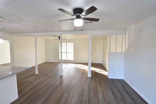 unfurnished living room featuring dark hardwood / wood-style floors and ceiling fan