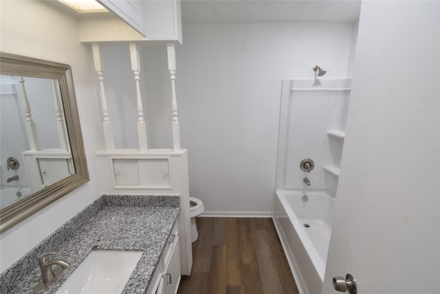 full bathroom with hardwood / wood-style flooring, vanity, shower / bathtub combination, and toilet