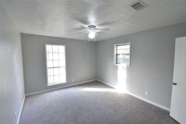 spare room featuring carpet flooring and ceiling fan