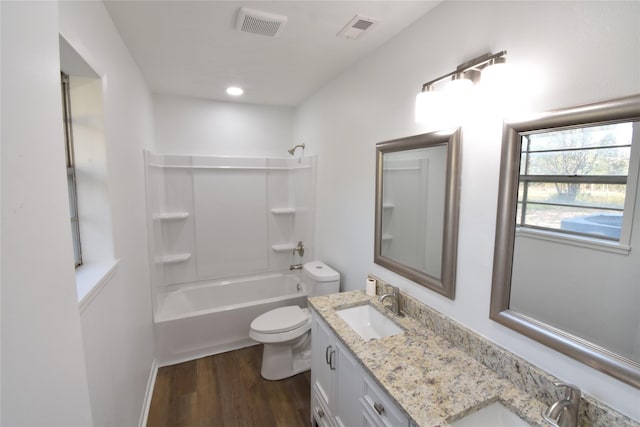 full bathroom with hardwood / wood-style floors, vanity, toilet, and tub / shower combination