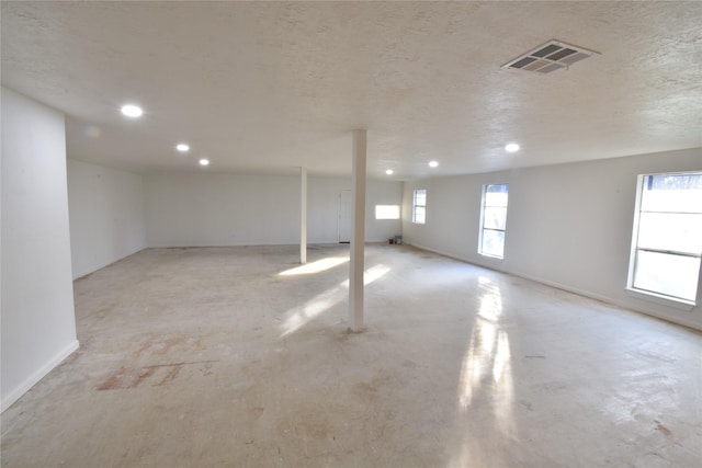 basement featuring a textured ceiling