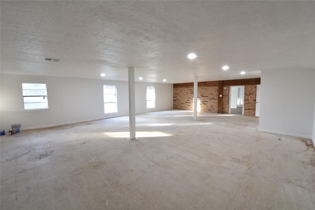 basement with plenty of natural light and a textured ceiling