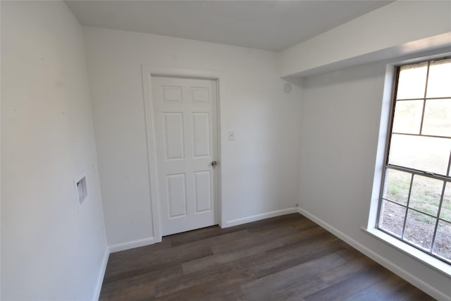 empty room with dark hardwood / wood-style flooring