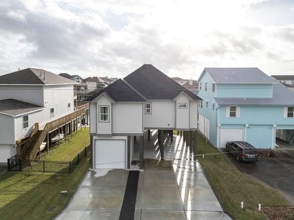 view of front of home with a garage and a front lawn