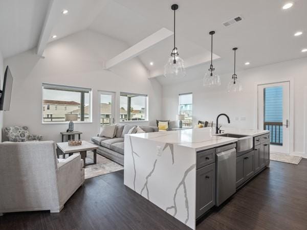 kitchen featuring sink, stainless steel dishwasher, hanging light fixtures, gray cabinets, and a center island with sink