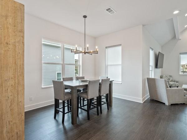 dining area featuring a chandelier and dark wood-type flooring