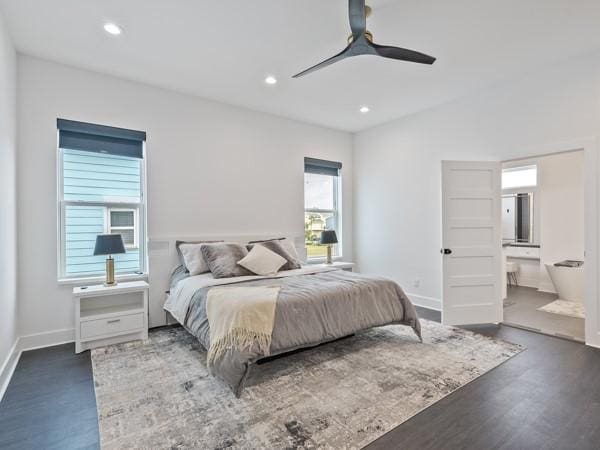 bedroom with connected bathroom, ceiling fan, and dark wood-type flooring