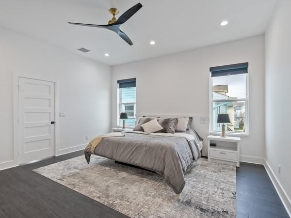 bedroom with ceiling fan and dark hardwood / wood-style floors