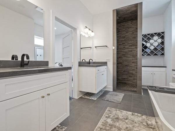 bathroom featuring tile patterned flooring, plus walk in shower, and vanity