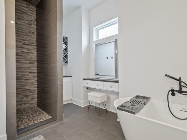 bathroom with tile patterned floors, independent shower and bath, and vanity