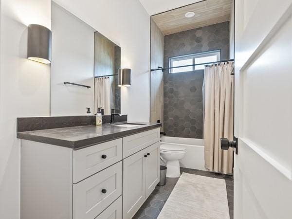 full bathroom featuring shower / bath combo with shower curtain, vanity, and toilet