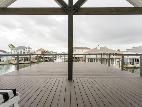 wooden deck featuring a boat dock and a water view