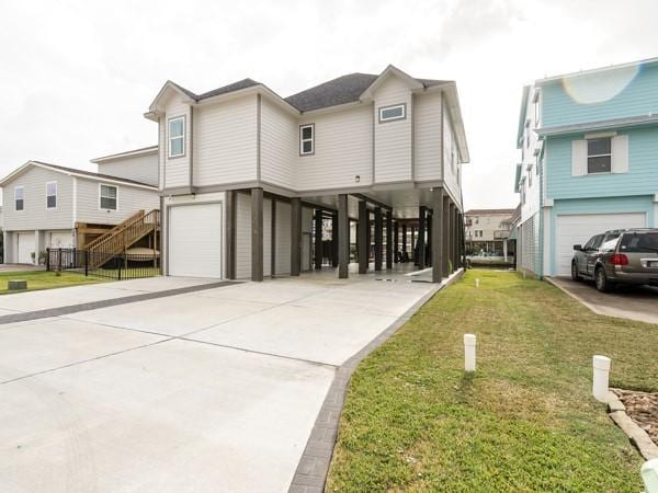 view of front of property with a garage, a front yard, and a carport