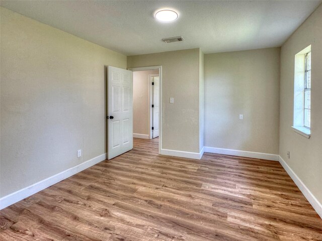 unfurnished room with light hardwood / wood-style flooring