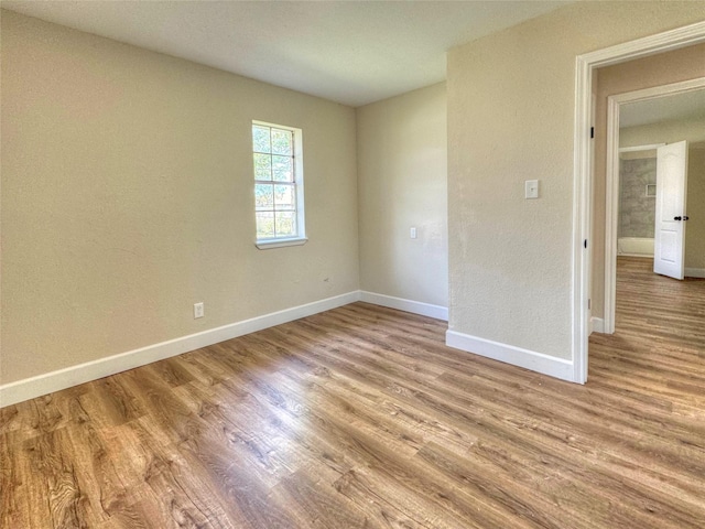 spare room featuring light wood-type flooring