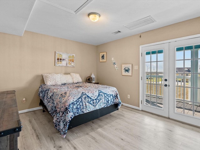 bedroom with french doors, access to outside, and light hardwood / wood-style flooring