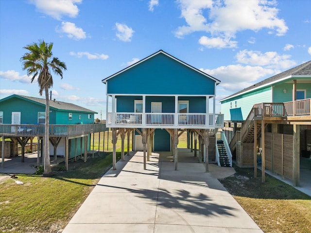 rear view of house with a carport and a lawn