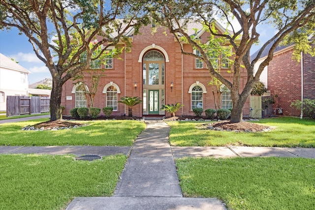 tudor-style house featuring a front yard