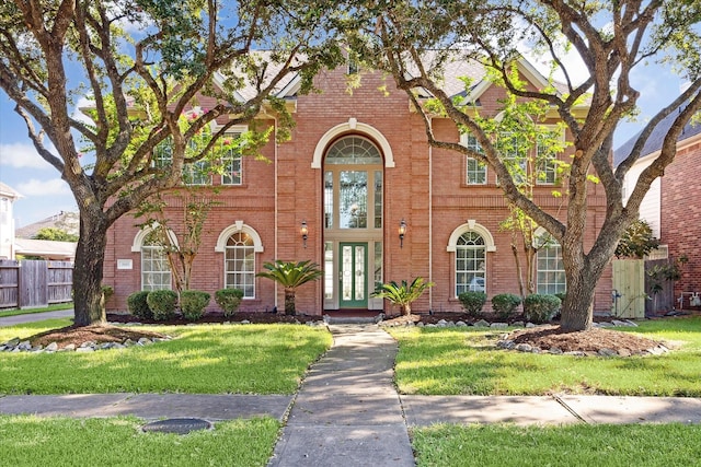 english style home featuring a front yard