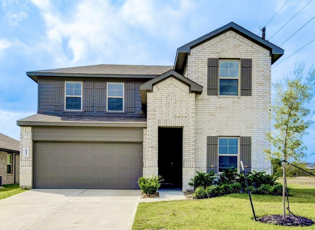 view of front of property with a front lawn and a garage