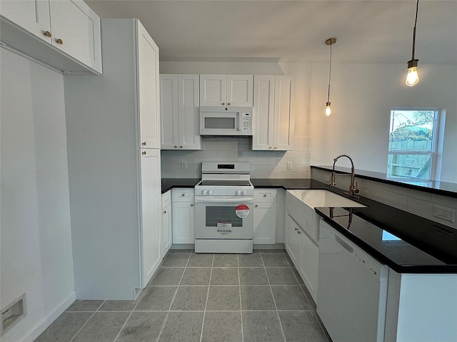 kitchen with white appliances, decorative light fixtures, white cabinetry, and sink