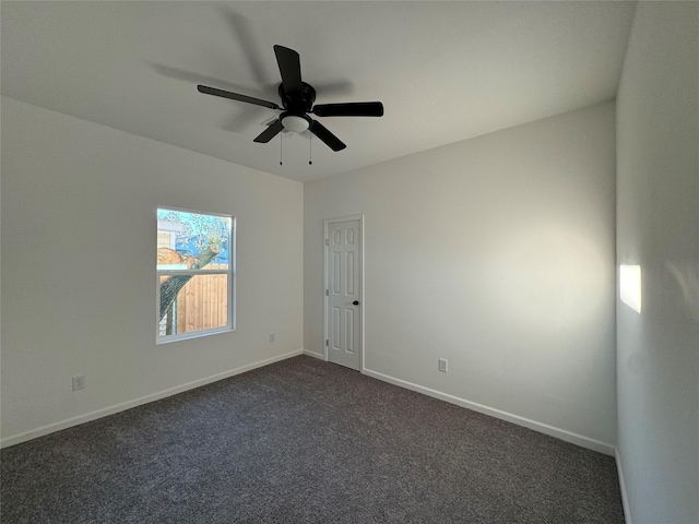 unfurnished room with ceiling fan and dark colored carpet