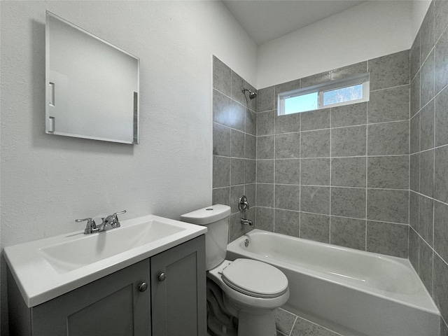 full bathroom with tiled shower / bath combo, toilet, and vanity