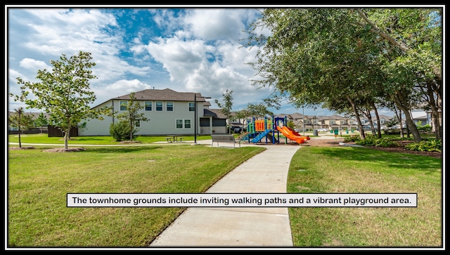 view of property's community with a playground and a yard