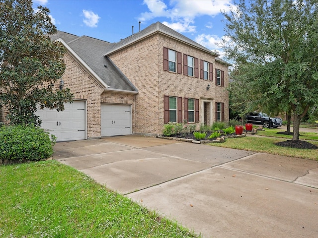 view of front of property with a garage and a front lawn