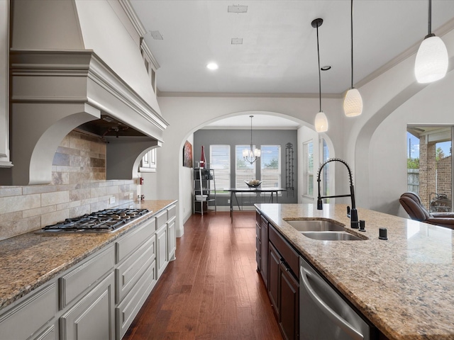 kitchen featuring decorative backsplash, ornamental molding, stainless steel appliances, dark wood-type flooring, and sink