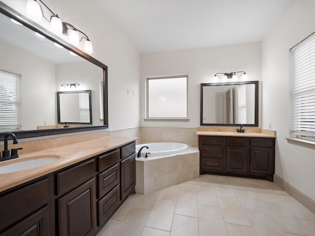 bathroom with tile patterned floors, a relaxing tiled tub, and vanity