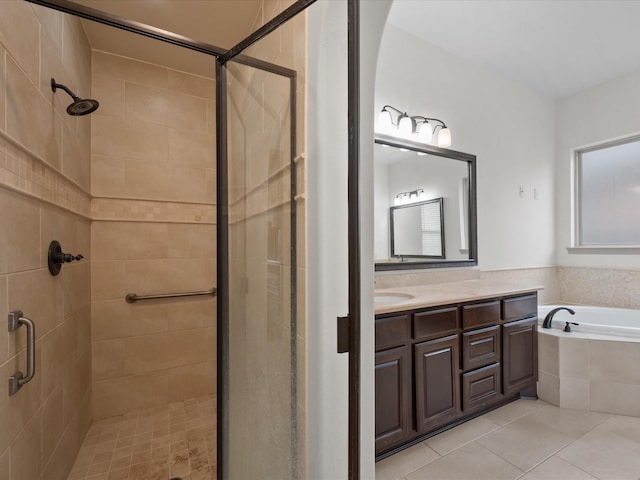 bathroom with tile patterned floors, vanity, and plus walk in shower